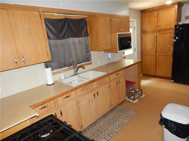 2031 Spruce St, Leavenworth, KS 66048 - kitchen featuring black appliances, decorative backsplash, light countertops, and light colored carpet