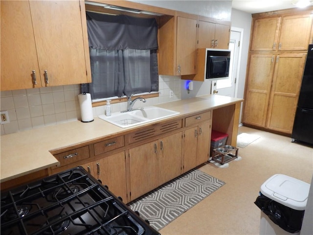 2031 Spruce St, Leavenworth, KS 66048 - kitchen with freestanding refrigerator, tasteful backsplash, and light countertops