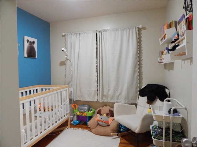 2031 Spruce St, Leavenworth, KS 66048 - bedroom featuring a nursery area and wood finished floors