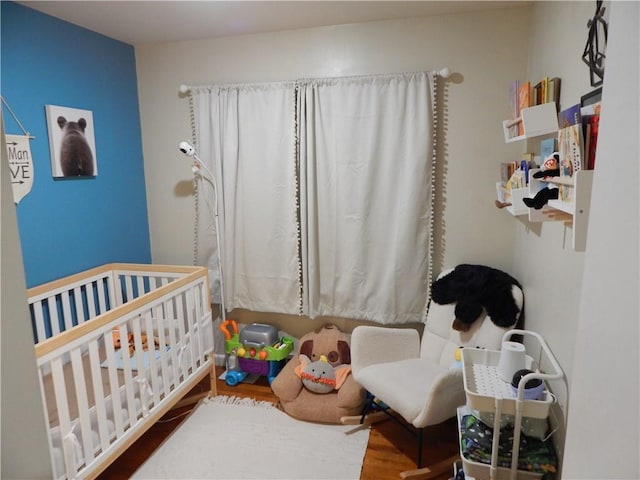 2031 Spruce St, Leavenworth, KS 66048 - bedroom with a crib and wood finished floors