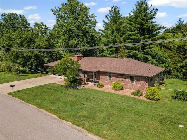 1306 Ruby St, Carrollton, MO 64633 - ranch-style house featuring driveway, a front yard, and a chimney