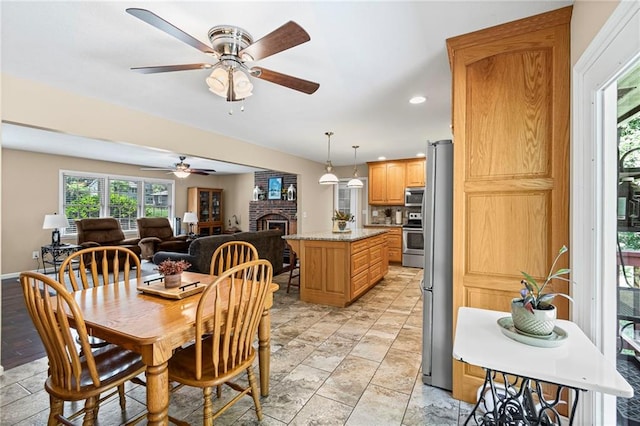 1306 Ruby St, Carrollton, MO 64633 - dining space featuring a ceiling fan, recessed lighting, and a fireplace