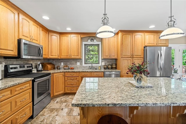 1306 Ruby St, Carrollton, MO 64633 - kitchen with appliances with stainless steel finishes, light stone counters, backsplash, recessed lighting, and hanging light fixtures