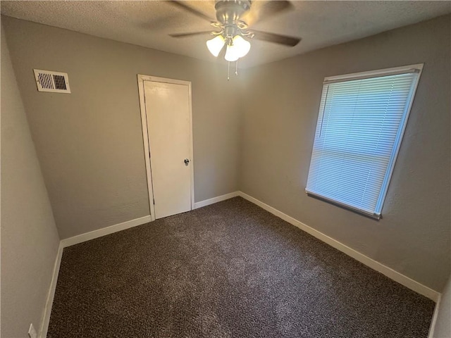 6146 Parkview Ave, Kansas City, KS 66104 - empty room with a ceiling fan and dark carpet