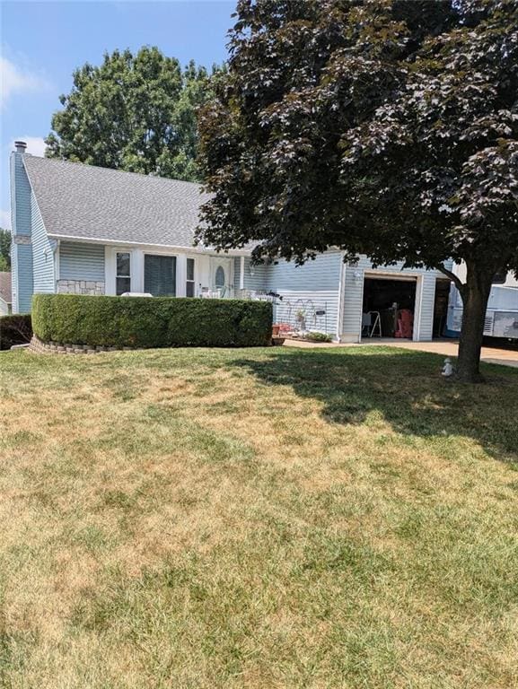 1309 N Annie St, Olathe, KS 66061 - view of front of home with a garage, a front lawn, and a chimney