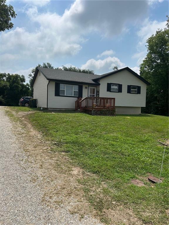 901-903 S Main St, Lansing, KS 66043 - view of front of property with driveway, a wooden deck, and a front yard