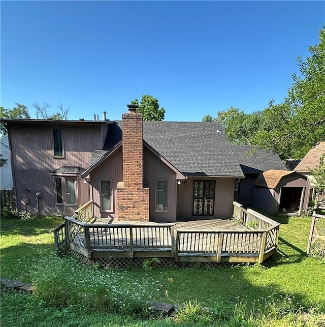 7908 E 96th St, Kansas City, MO 64134 - back of house with roof with shingles, a chimney, a lawn, and a wooden deck