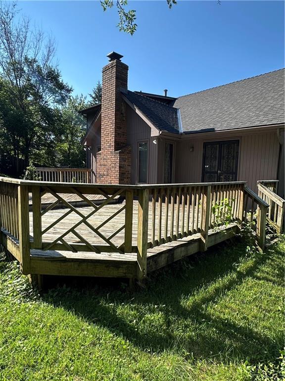 7908 E 96th St, Kansas City, MO 64134 - wooden deck featuring a yard