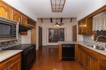 7908 E 96th St, Kansas City, MO 64134 - kitchen with black appliances, brown cabinetry, and tasteful backsplash