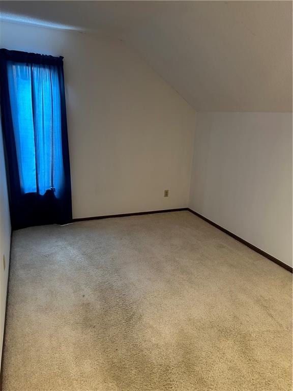 7908 E 96th St, Kansas City, MO 64134 - additional living space with light colored carpet and lofted ceiling