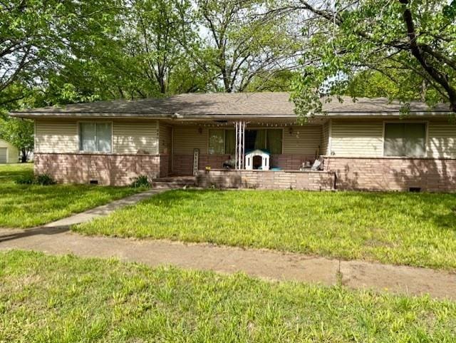 2302 Crawford Ave, Parsons, KS 67357 - ranch-style home featuring brick siding, a porch, a front lawn, and crawl space