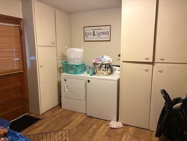2302 Crawford Ave, Parsons, KS 67357 - laundry room featuring light wood-style floors, washing machine and dryer, and cabinet space
