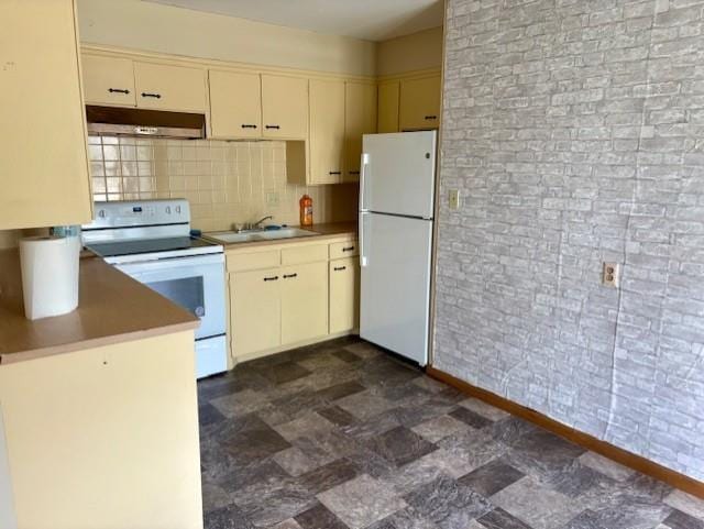 2302 Crawford Ave, Parsons, KS 67357 - kitchen featuring white appliances, cream cabinets, under cabinet range hood, decorative backsplash, and light countertops