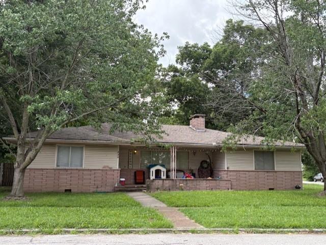 2302 Crawford Ave, Parsons, KS 67357 - single story home with brick siding, a front yard, and a chimney