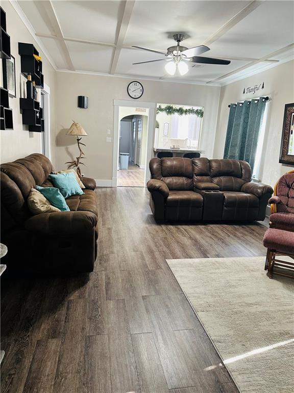 507 E Jefferson St, Pittsburg, KS 66762 - living room with coffered ceiling, arched walkways, wood finished floors, ceiling fan, and beamed ceiling