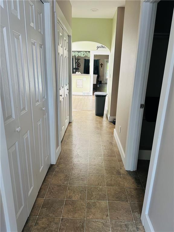 507 E Jefferson St, Pittsburg, KS 66762 - corridor with arched walkways and dark stone finish floors