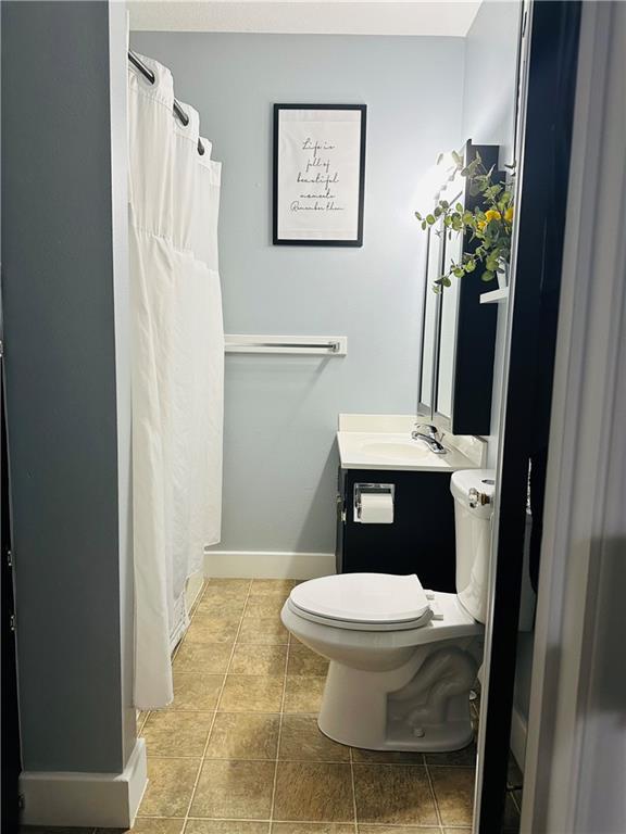 507 E Jefferson St, Pittsburg, KS 66762 - full bathroom with vanity, a shower with curtain, and tile patterned flooring