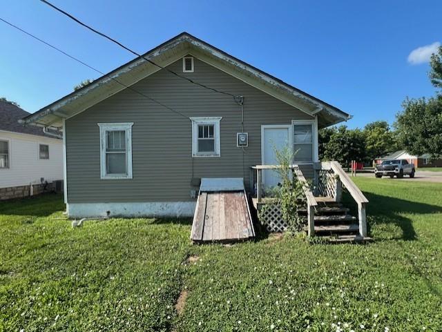 1110 W Main St, Chanute, KS 66720 - back of house featuring a lawn