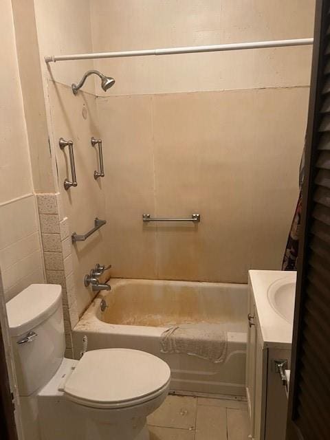 1110 W Main St, Chanute, KS 66720 - bathroom featuring tile patterned floors, tub / shower combination, vanity, and tile walls