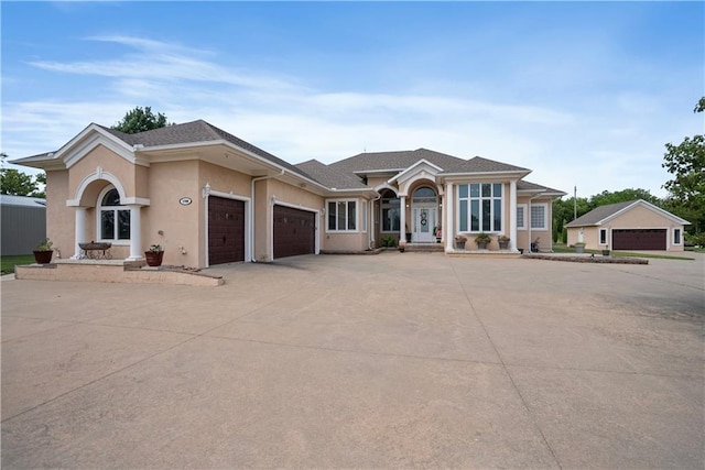 1702 Cedar Ridge Rd, Parsons, KS 67357 - ranch-style house with a garage, stucco siding, driveway, and roof with shingles