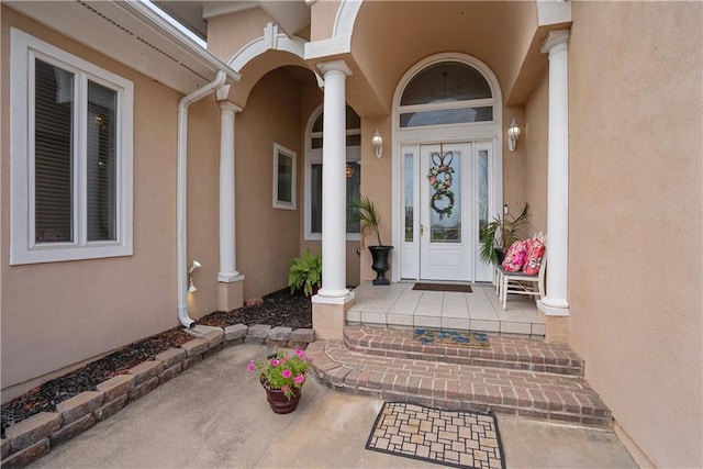1702 Cedar Ridge Rd, Parsons, KS 67357 - view of exterior entry with stucco siding and a porch