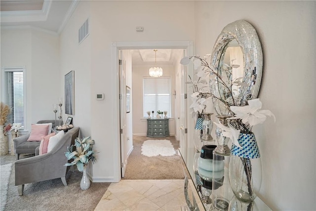 1702 Cedar Ridge Rd, Parsons, KS 67357 - hallway featuring healthy amount of natural light, ornamental molding, light carpet, and a chandelier