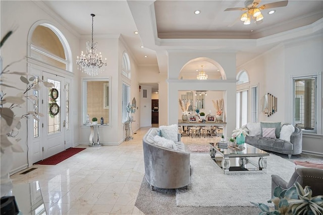 1702 Cedar Ridge Rd, Parsons, KS 67357 - foyer featuring a chandelier, crown molding, light marble finish flooring, a ceiling fan, and a raised ceiling