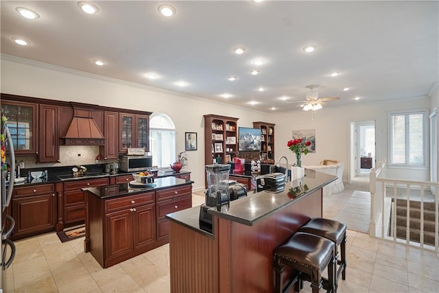 1702 Cedar Ridge Rd, Parsons, KS 67357 - kitchen featuring a center island, dark countertops, ornamental molding, custom exhaust hood, and backsplash