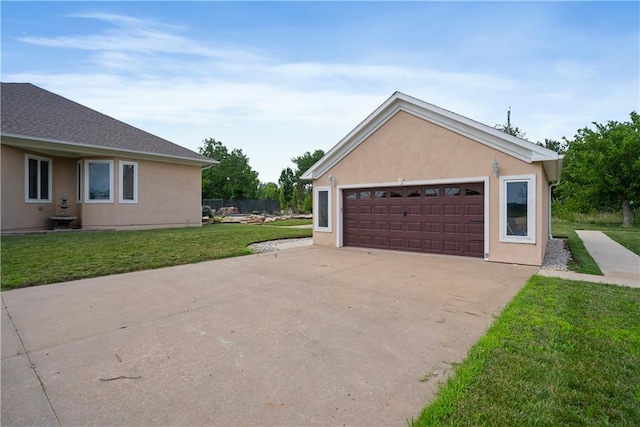 1702 Cedar Ridge Rd, Parsons, KS 67357 - view of side of property with stucco siding, a lawn, and a detached garage