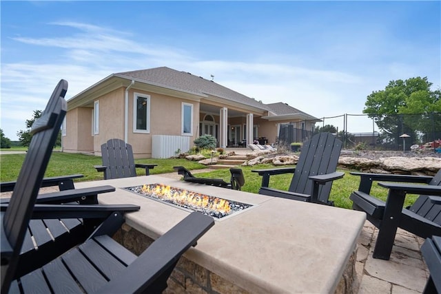 1702 Cedar Ridge Rd, Parsons, KS 67357 - back of house featuring an outdoor fire pit and stucco siding