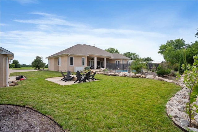 1702 Cedar Ridge Rd, Parsons, KS 67357 - back of property featuring a patio area, stucco siding, and an outdoor pool