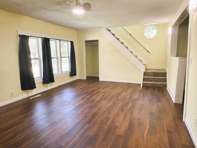 621 N 3rd St, Burlington, KS 66839 - unfurnished living room with ceiling fan, wood finished floors, stairs, and a textured ceiling