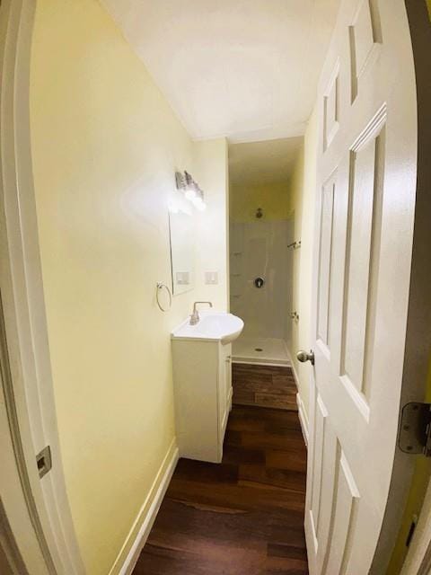621 N 3rd St, Burlington, KS 66839 - bathroom with vanity, a walk in shower, and wood finished floors