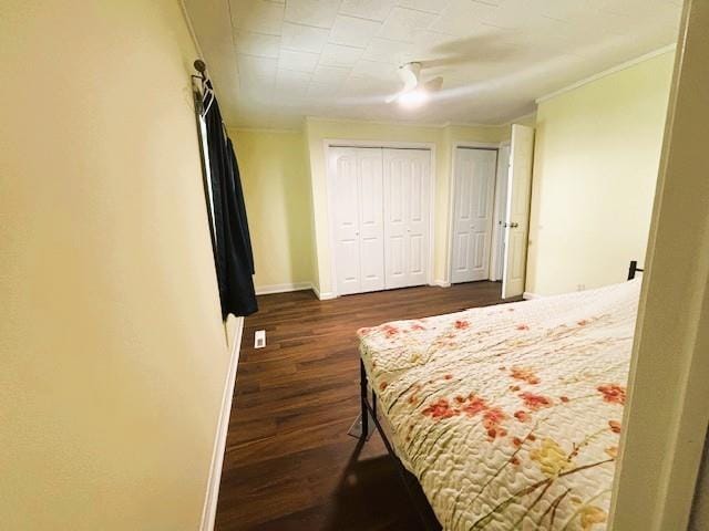 621 N 3rd St, Burlington, KS 66839 - bedroom featuring dark wood-type flooring, two closets, and crown molding