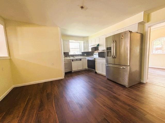 621 N 3rd St, Burlington, KS 66839 - kitchen with appliances with stainless steel finishes, white cabinets, dark wood-type flooring, and light countertops