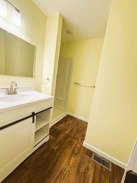 621 N 3rd St, Burlington, KS 66839 - full bath with wood finished floors, vanity, and a shower