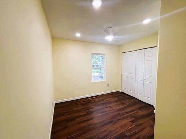 621 N 3rd St, Burlington, KS 66839 - unfurnished bedroom featuring dark wood finished floors, recessed lighting, and a closet