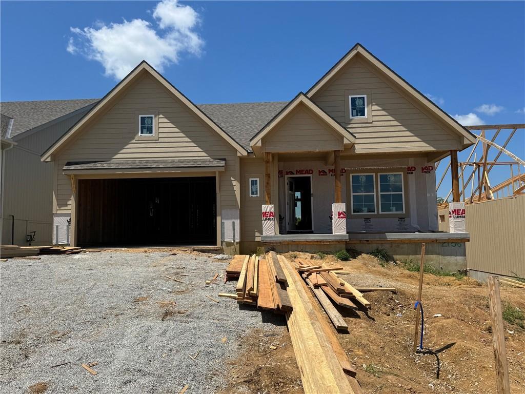 2156 Black Walnut Dr, Liberty, MO 66085 - property under construction with a garage, a porch, a shingled roof, and gravel driveway