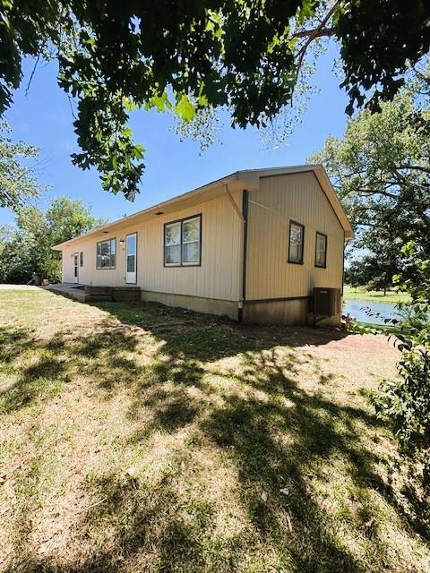 143 N 3rd St, New Strawn, KS 66839 - view of home's exterior featuring a lawn