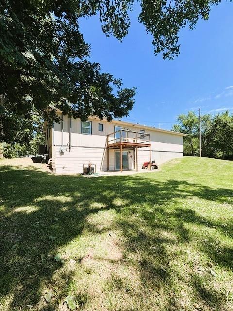 143 N 3rd St, New Strawn, KS 66839 - back of property with a yard and a deck