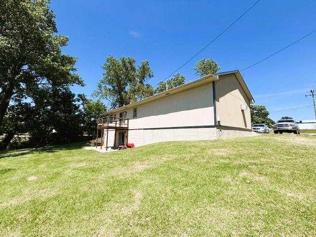 143 N 3rd St, New Strawn, KS 66839 - view of home's exterior featuring a lawn and a deck