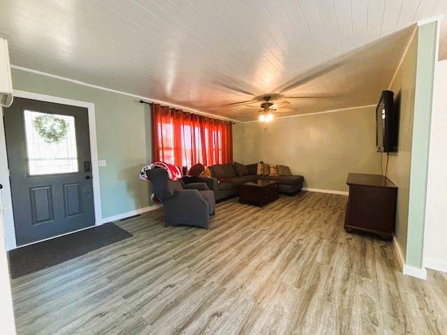 143 N 3rd St, New Strawn, KS 66839 - living area with plenty of natural light, light wood-style floors, wood ceiling, and a ceiling fan