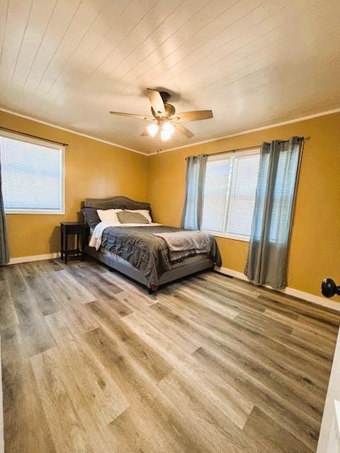 143 N 3rd St, New Strawn, KS 66839 - bedroom with multiple windows, wood finished floors, ceiling fan, crown molding, and wooden ceiling