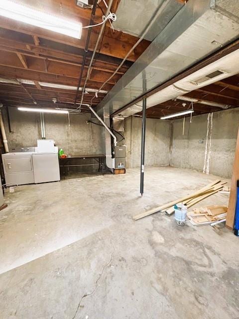 143 N 3rd St, New Strawn, KS 66839 - unfinished basement featuring washing machine and clothes dryer and heating unit
