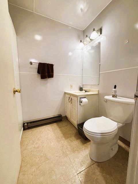143 N 3rd St, New Strawn, KS 66839 - bathroom with baseboard heating, vanity, and tile patterned floors