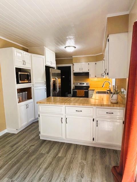 143 N 3rd St, New Strawn, KS 66839 - kitchen featuring white cabinets, a peninsula, appliances with stainless steel finishes, dark wood finished floors, and light countertops