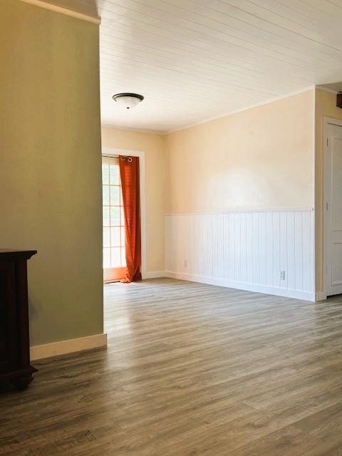 143 N 3rd St, New Strawn, KS 66839 - unfurnished room with wood finished floors, crown molding, and wainscoting