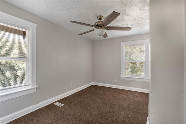 4001 Tracy Ave, Kansas City, MO 64110 - spare room with dark carpet and a ceiling fan