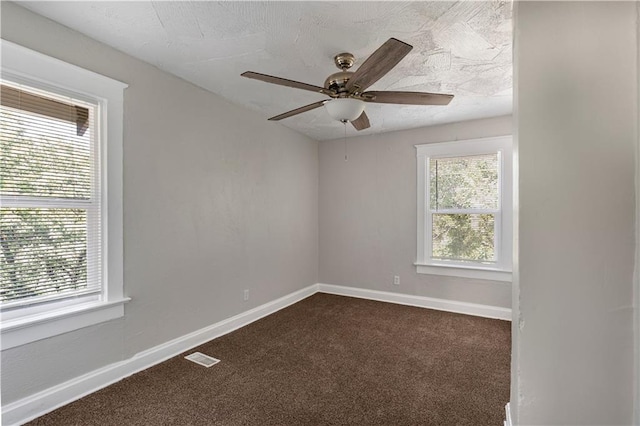 4001 Tracy Ave, Kansas City, MO 64110 - unfurnished room with dark colored carpet and ceiling fan