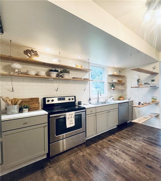 1643 Jefferson St, Kansas City, MO 64108 - kitchen with stainless steel appliances, open shelves, dark wood-style floors, and gray cabinetry
